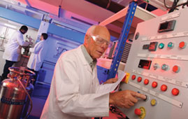 old man in lab pressing buttons